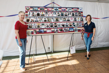 Carol Andrews and Chris Seifert standing alongside the Veterans Honor Board they both prepared. undefined