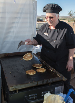 Mary Le Compte flipping pancakes on the newly purchased griddle. undefined