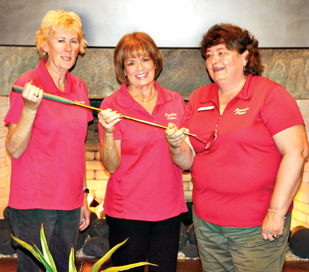 Passing of Putter: past Co-Presidents Linda Bowman and Janice Neal on left, pass the Putter to new President, Linda Shannon-Hills. Photo by Bob Hills undefined