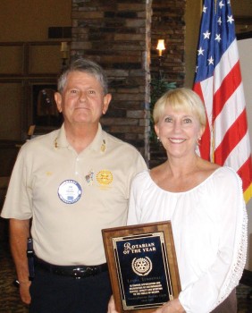 Rotary Club of SaddleBooke President Jim Lamb awards Linda Turbyfill with the Rotarian of the Year honor.