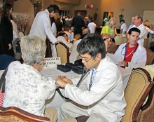 U of A Pharmacy student testing a SaddleBrooke resident at the Health Fair.