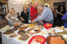 Judi Slavin-Cosel adding more latkes to the lavish buffet of holiday delights. Photo by Steve Weiss