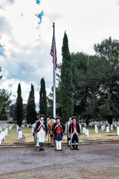 Sons of the American Revolution standing under the flag