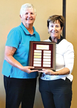 SBRWGA President Joyce DeYoung presents the President’s Cup Plaque to first place winner Mary Snowden.