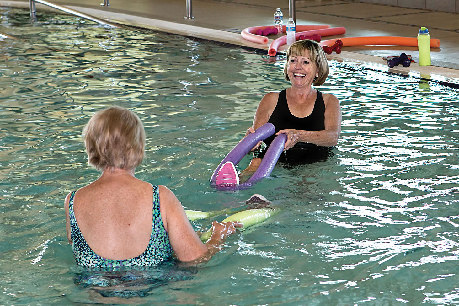 Helga Stone, left, being given special instructions before class by instructor Cathy Lair; photo by Steve Weiss