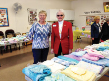 Before…Joan Hansen and Barb Carter help to organize and sort all donated items from the Knit-Wits baby shower for Tucson Troop Support.