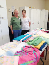 Dianne Resseguie and Marlene Jolly, both residents of SBR, admire the piles of hand-knitted items ready for delivery.