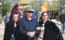 Old Tucson Street – While Linda Nicholson looks on from behind, left, Mike Nicholson enjoys the sights at Old Tucson Studios with two dance hall girls.
