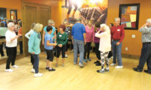 This is not how you line dance in Rebecca’s classes. Like most school groups, getting ready for a picture is like herding cats. In Rebecca’s class we always let those in witness protection decline to participate. These are is some of your neighbors deciding how their hair looks.