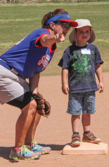 Coach Janice Mihora offers some guidance to young Travis. Photo by Jim Smith.