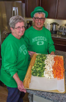 Kathy and Ernie Nedder showing a tray of vegetables in the form of an Irish flag; photo by Steve Weiss
