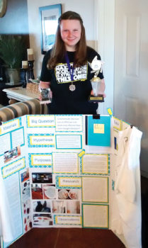 Elena Hendrix with her project board and all her awards