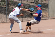 Competitive game: Harold Weinenger reaches to tag runner Don Jones as he stirs up the dust at third base. Photo by Dennis Purcell