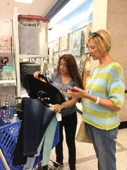 Marlene Diskin, a resident of SaddleBrooke Ranch, helps a Teen Closet shopper determine how much money she has left to spend.