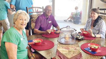 Irene and Bill Keil and Bobbie Spiegel swap Texas stories over a bowl of Blue Bell ice cream.