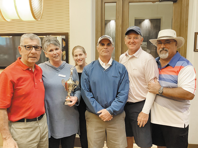 Kathy Dahlin presented the first-place men’s tournament trophy to the winning team (left to right): Ernie Nedder, Kathy Dahlin, Amanda Dahlin, Bill Oprish, Stan Doepke, and Dave Blaess.