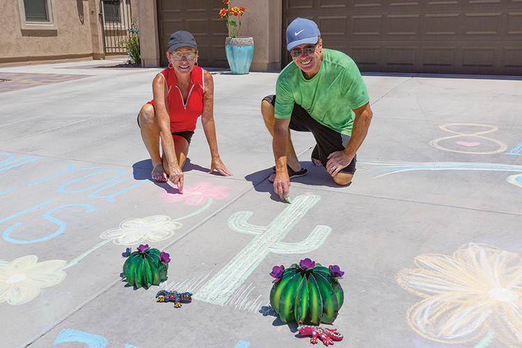 Larry and Teresa Burchfield’s original poem and accompanying illustrations won the Most Creative award in Unit 8A’s 50th Happy Hour driveway display contest. (Photo by Steve Weiss)