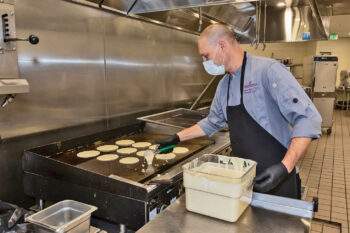 Jeremy Immes, Director of food and beverage, making pancakes for the event. (Photo by Steve Weiss)