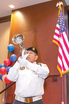 Bugler Rick Gonzales playing Taps to honor the fallen troops. (Photo by Steve Weiss)