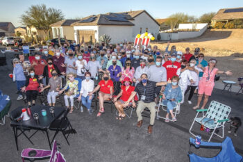 Residents of Unit 8A pose for the traditional group photo, memorializing another year of monthly happy hours. (Photo by Steve Weiss)